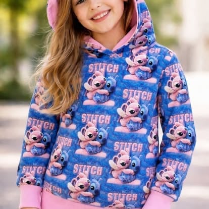 Young girl wearing a blue Stitch-patterned hoodie with pink accents and long brown hair, smiling outdoors